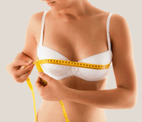 The girl measures the bust with one centimeter